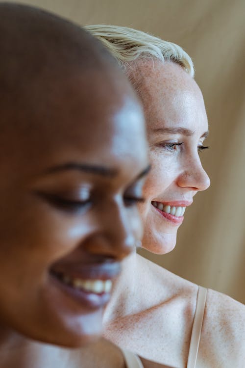 Pleasant woman with blond hair near black model