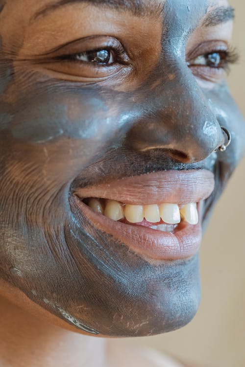 Black woman with purifying mask on face