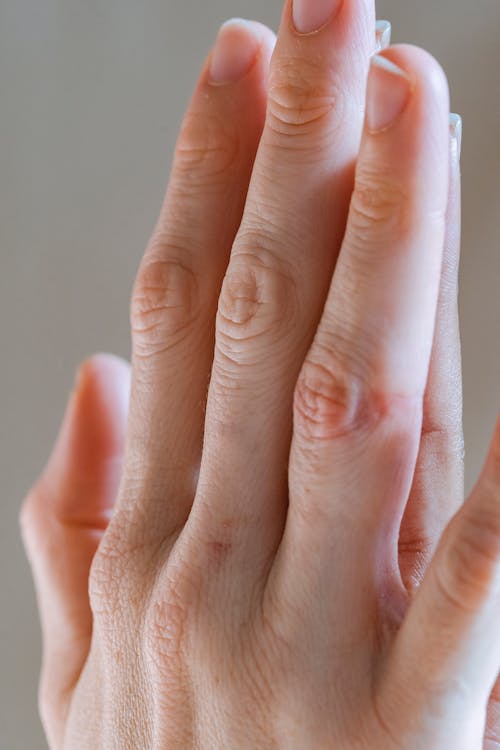 Women gently touching palms for support