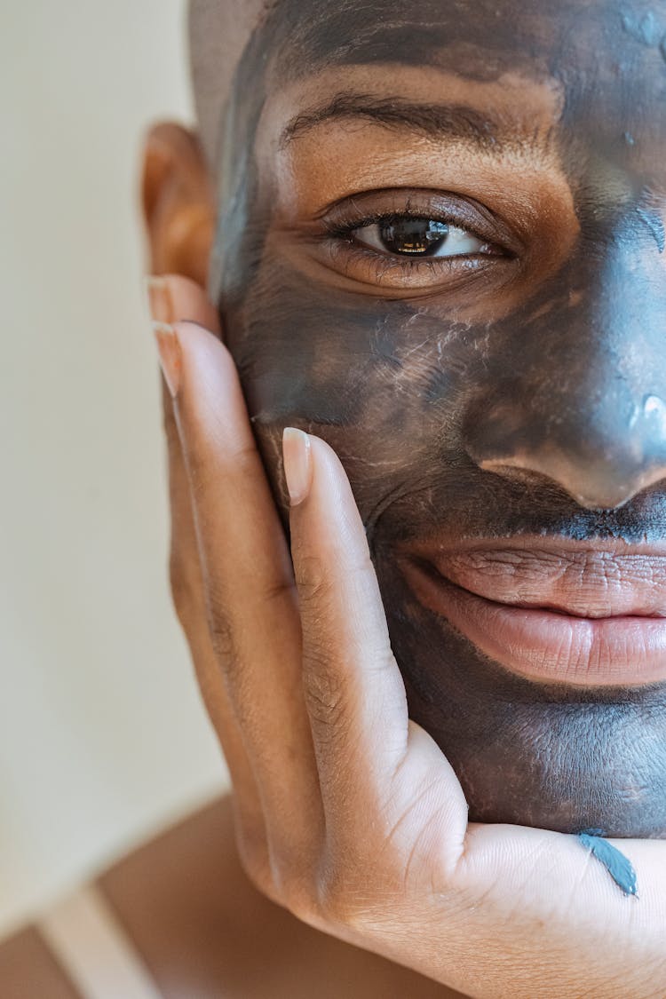 Crop Woman With Cosmetic Mask On Face Leaning On Hand