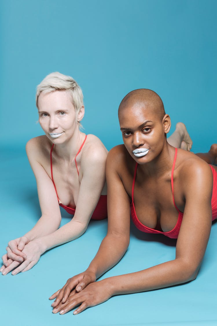 Multiracial Models With White Lips Lying In Studio