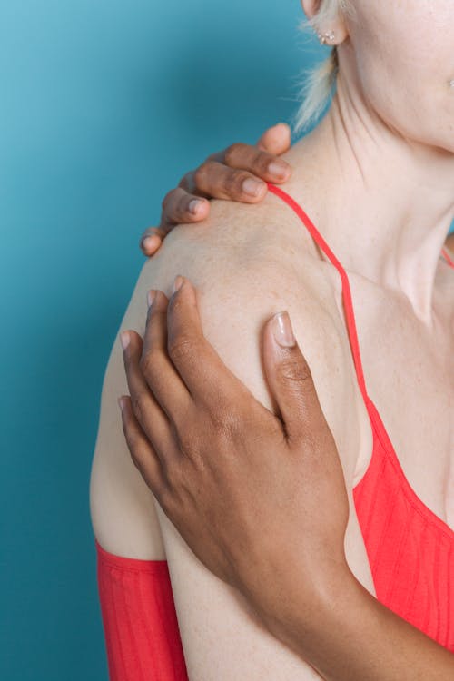 Free Anonymous multiracial girlfriends hugging in studio Stock Photo