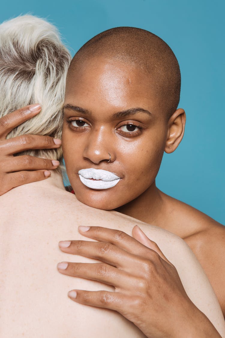 Multiracial Girlfriends With White Lips Hugging In Studio