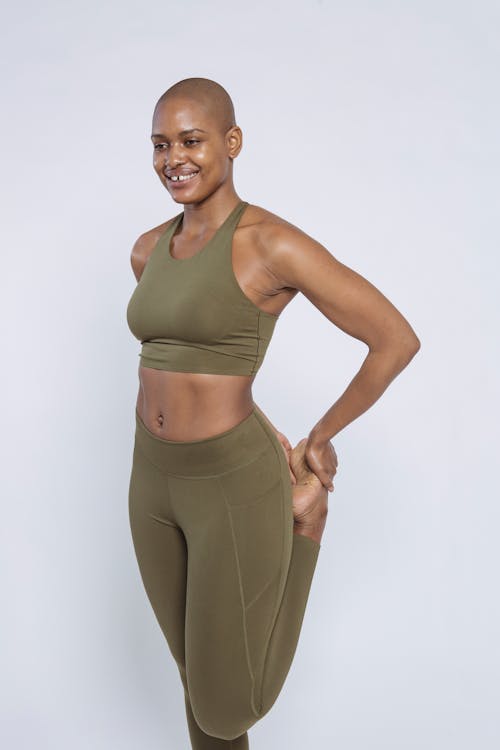 Free Flexible black woman in sportswear standing in studio Stock Photo