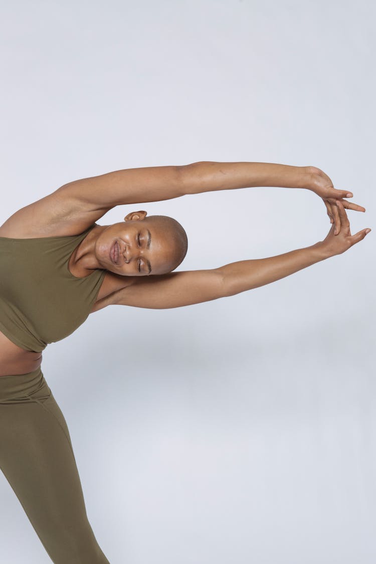 Woman Closing Eyes While Straightening Arms And Bending Aside