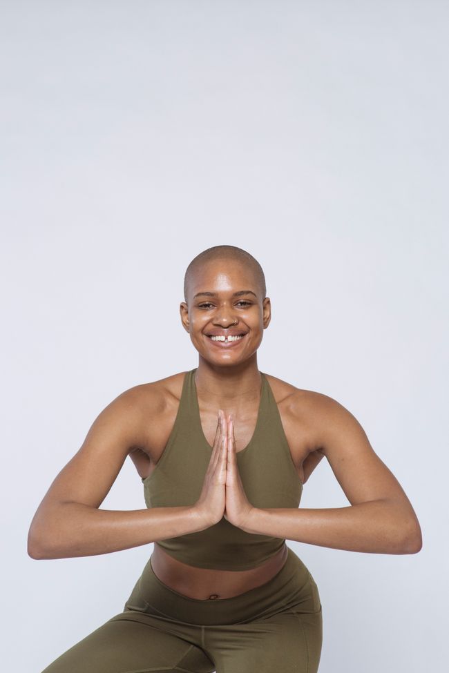 Model in an olive support tank in a bright studio — photo by Angela Roma on Pexels
