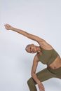 Studio shot of black woman doing Utthita Parsvakonasana