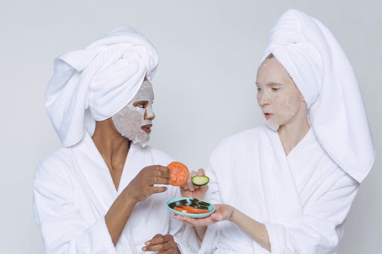 Multiethnic Women In Sheet Masks And Towel With Bathrobe