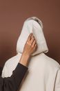 Unrecognizable model in hoodie near anonymous person