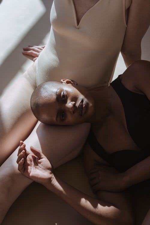 Free Pensive black female lying in woman in studio Stock Photo