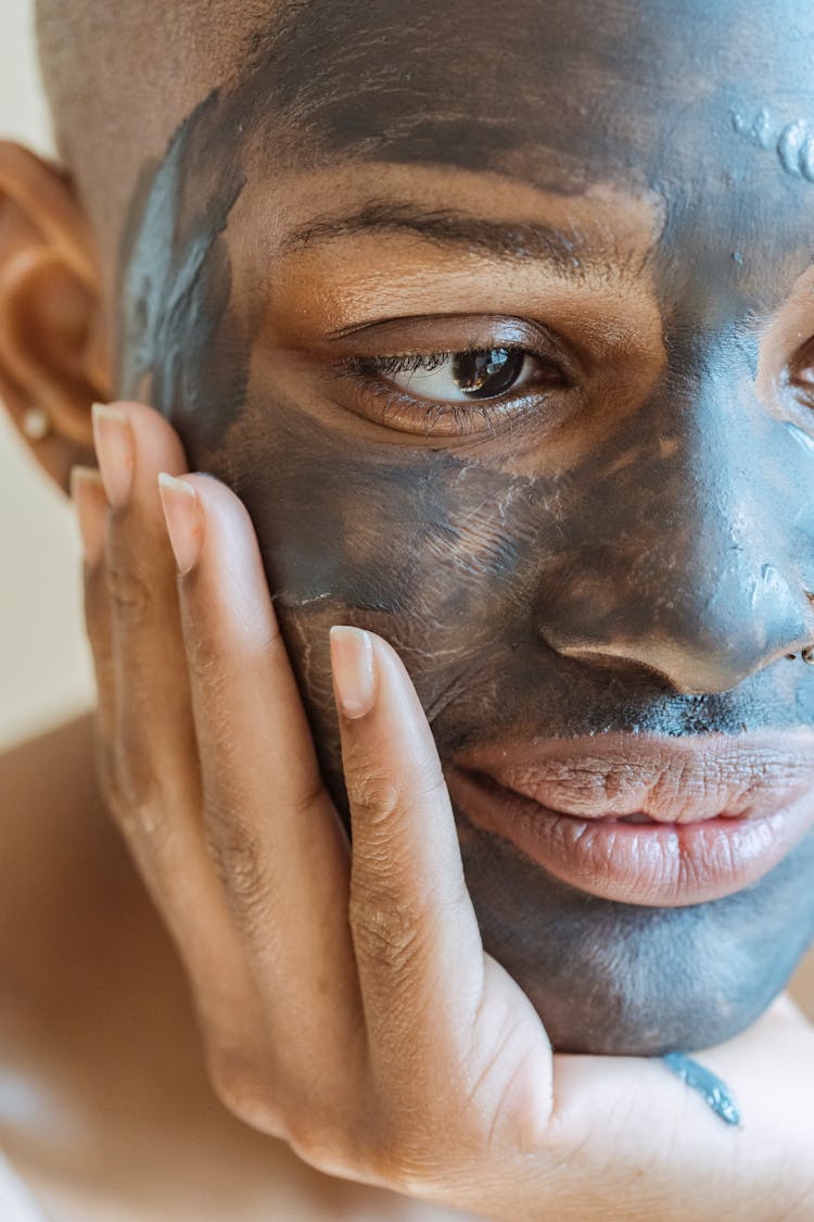 Black Woman In Facial Mask Looking Away