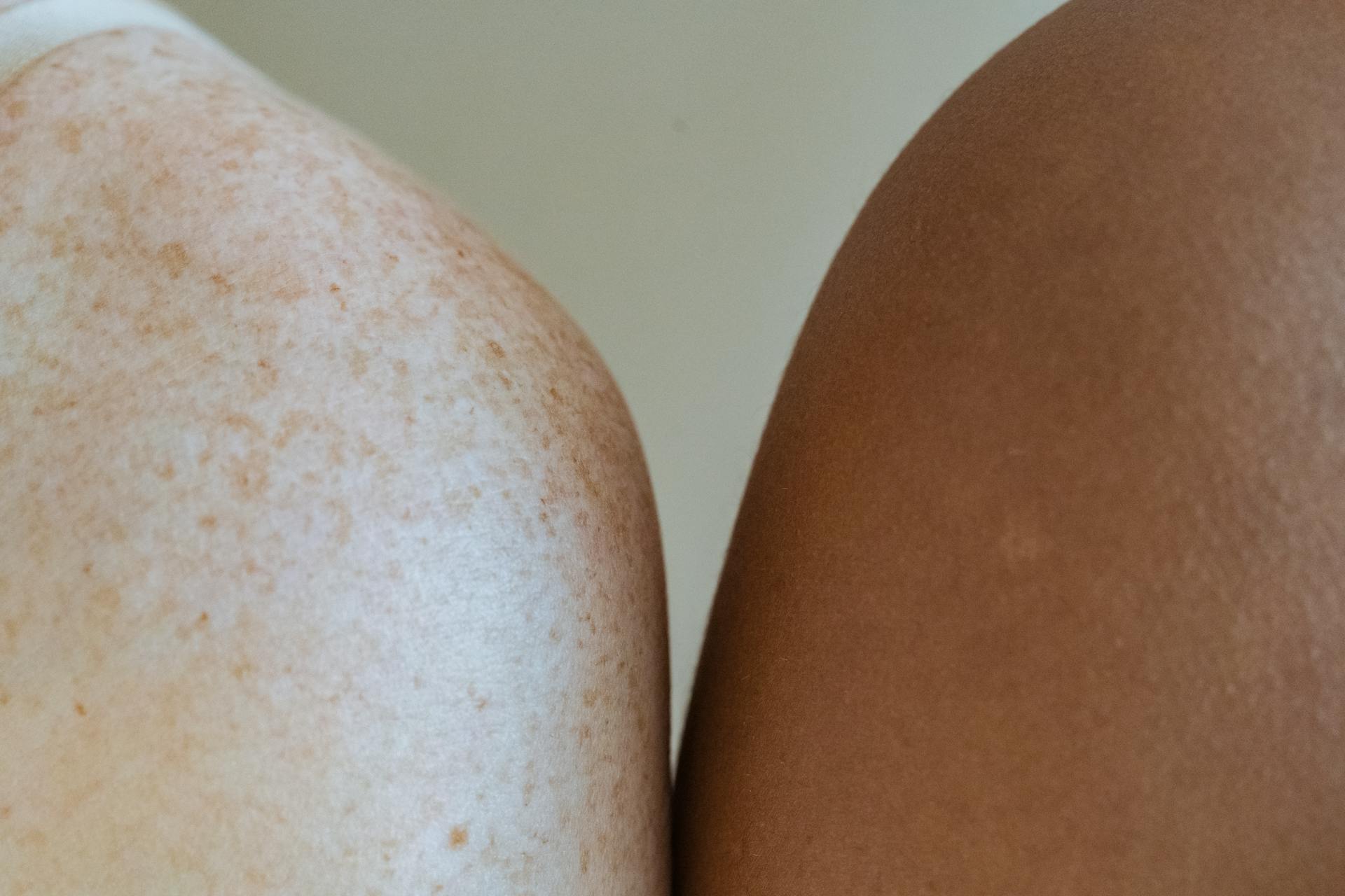 Shoulders of multiracial models against light wall