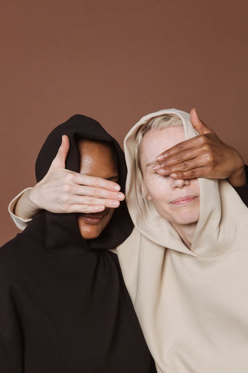 Free Calm women covering eyes of each other Stock Photo