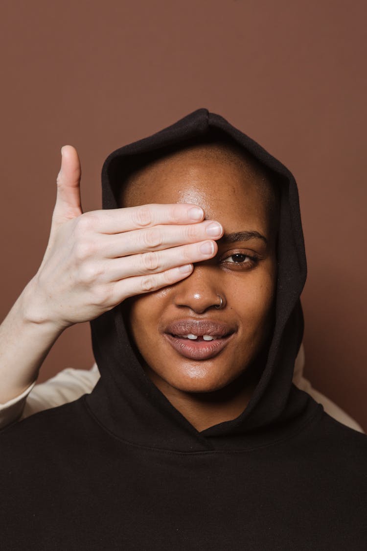 Black Woman In Hoodie With Covered Eye