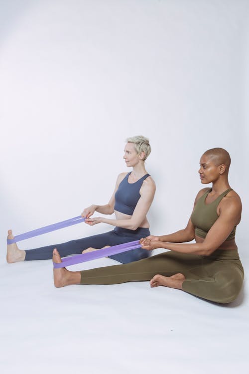Free Multiracial sportswomen exercising with elastic bands Stock Photo