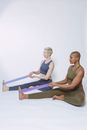 Multiracial sportswomen exercising with elastic bands
