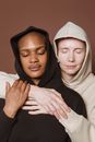 Multiracial female models hugging with closed eyes
