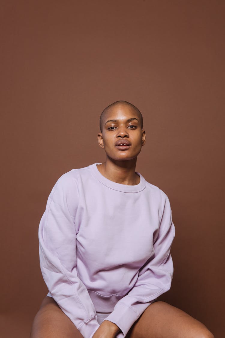 Black Female Model Sitting In Studio