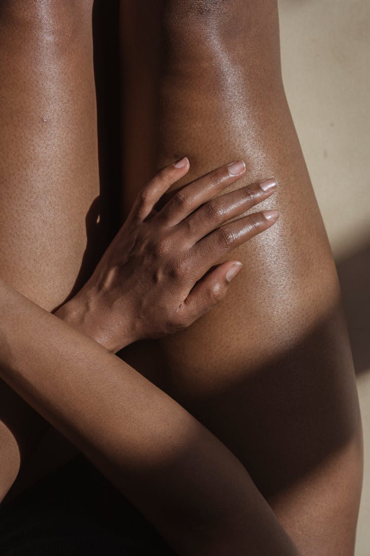 Crop Naked Black Woman Touching Hip