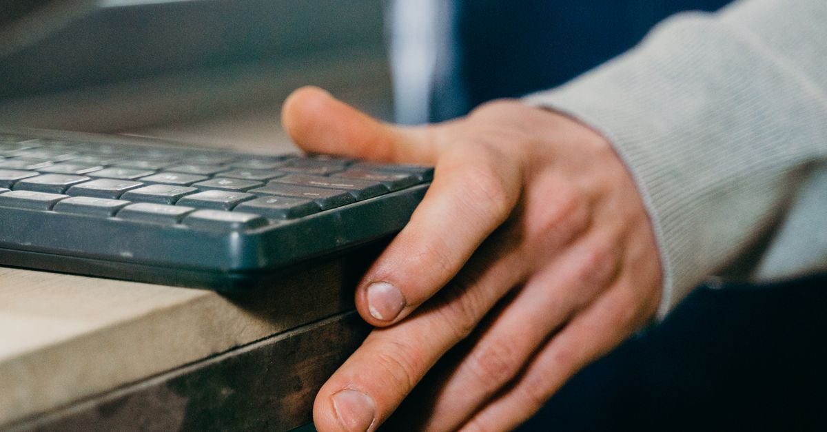 Man Using Keyboard Close-up Man Using a Keyboard to Operate a Machine in a Factory · Free ...
