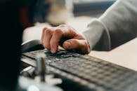 Man Writing on a Keyboard