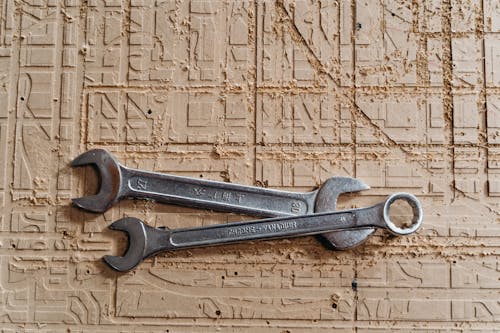 Gray Steel Tools on Brown Textile