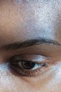 Closeup of crop face of ethnic anonymous female with black eyes and delicate eyebrows