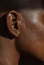 Side view of crop face of anonymous African American lady with piercing in ear