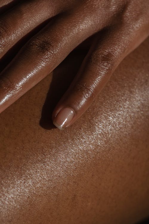 Free Crop ethnic person touching bare skin Stock Photo
