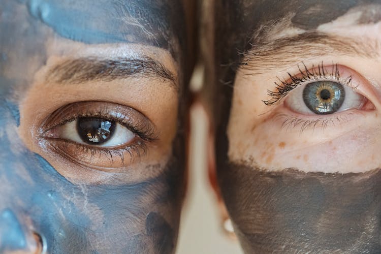 Crop Multiethnic Women With Clay Mask On Faces