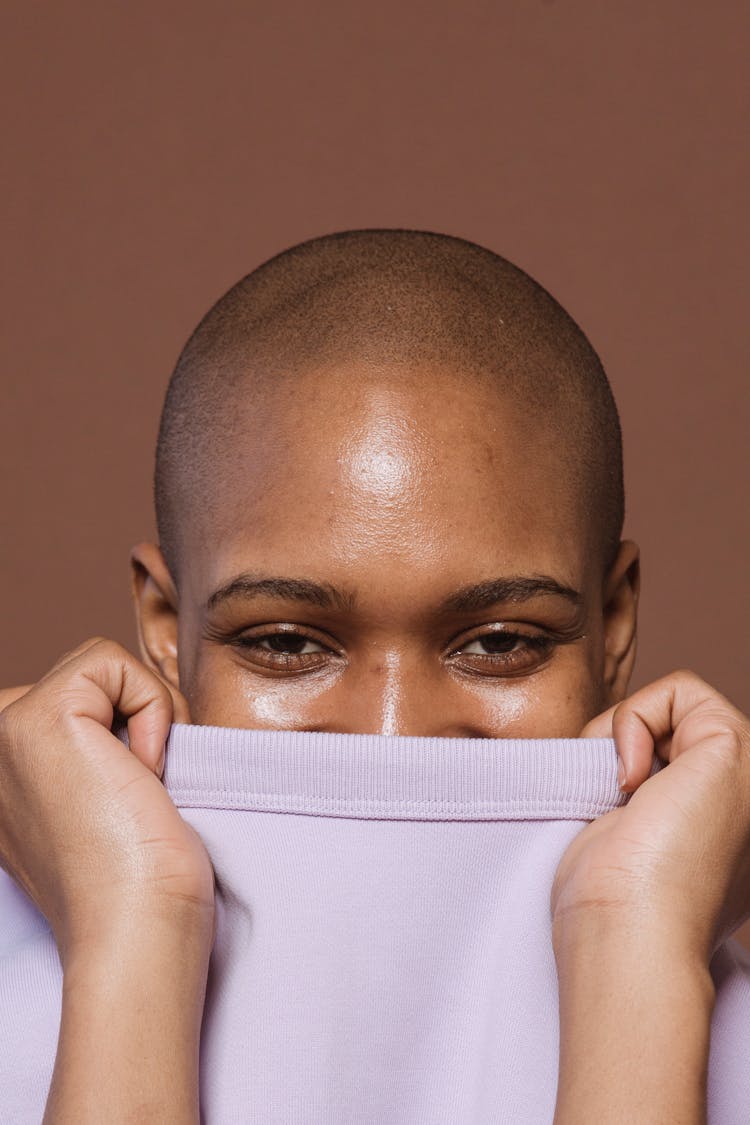 Positive Black Woman Covering Half Face With T Shirt