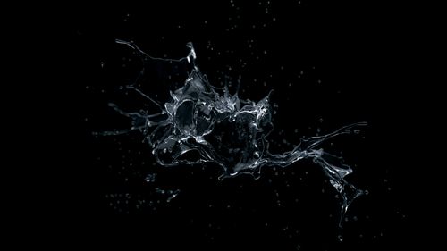 Free Captivating splash of water frozen in motion on a dark background. Stock Photo
