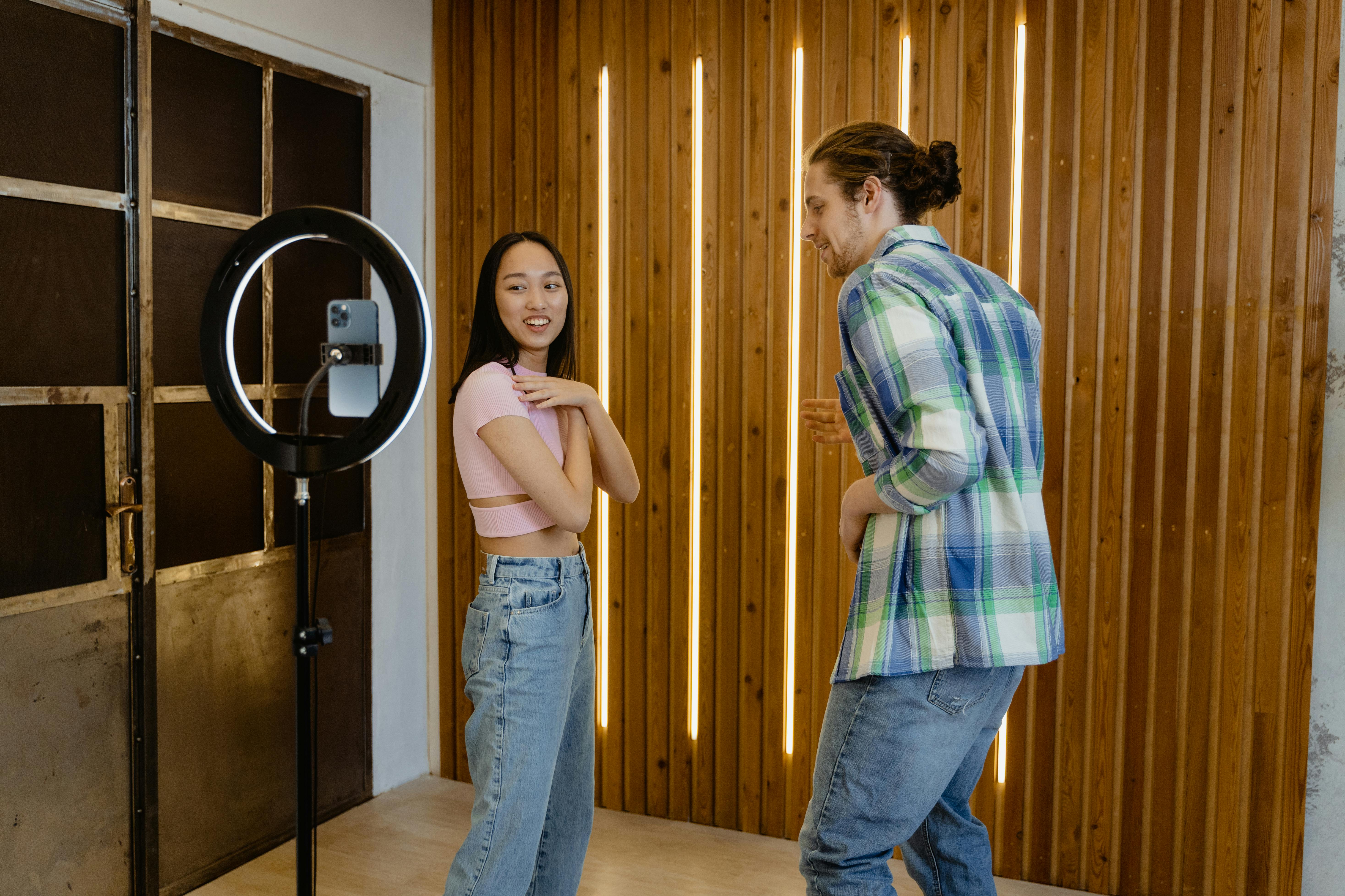 man in blue denim jeans standing beside woman in plaid shirt