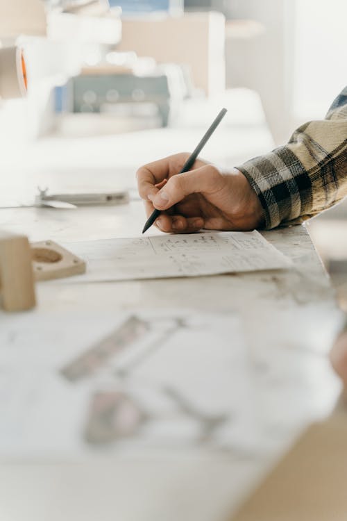 Person Writing on White Paper