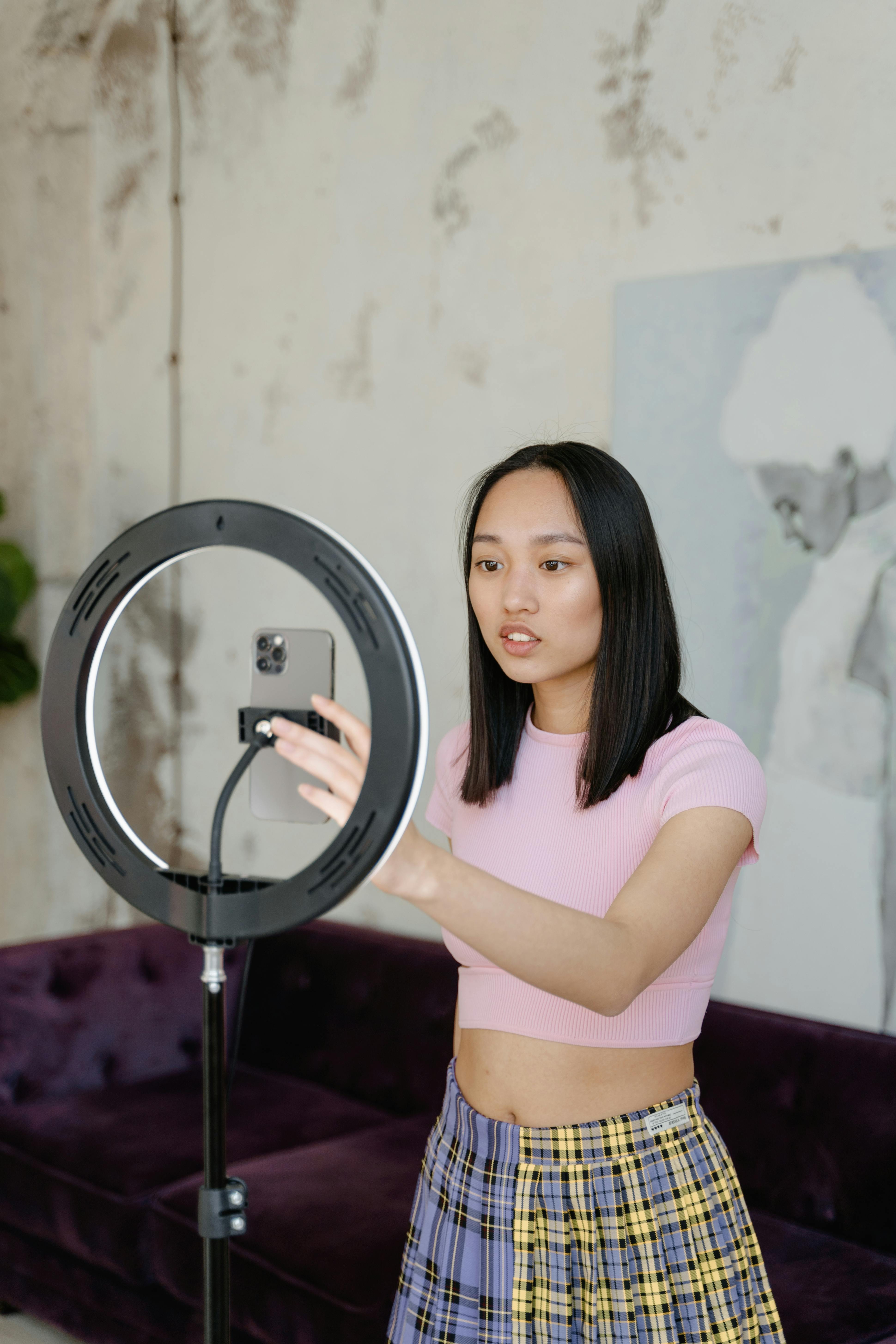 Woman in Pink Crop Top and Blue Denim Daisy Dukes Standing Near Round  Mirror · Free Stock Photo