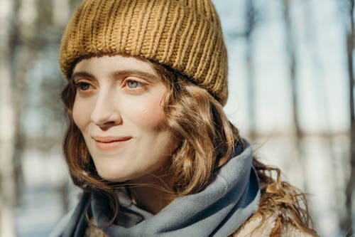 Selective Focus Photo of a Woman Wearing a Brown Knitted Cap