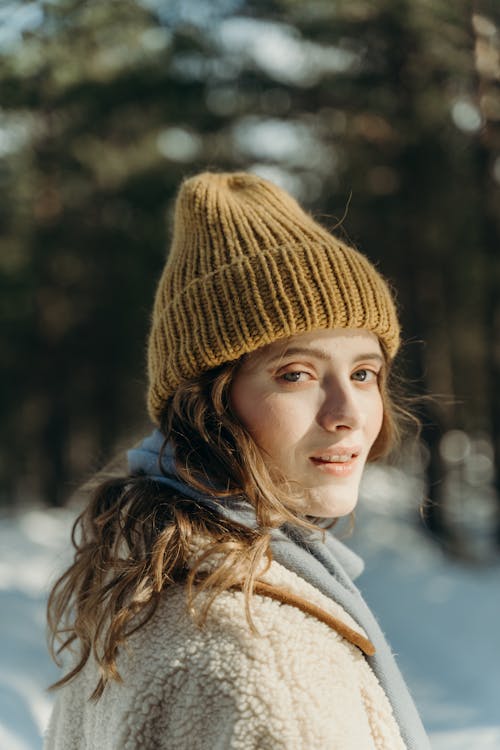 Free Portrait of a Beautiful Woman Wearing a Mustard Knitted Cap Stock Photo
