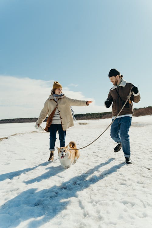 Free Man Running While Holding the Leash of a Dog Stock Photo