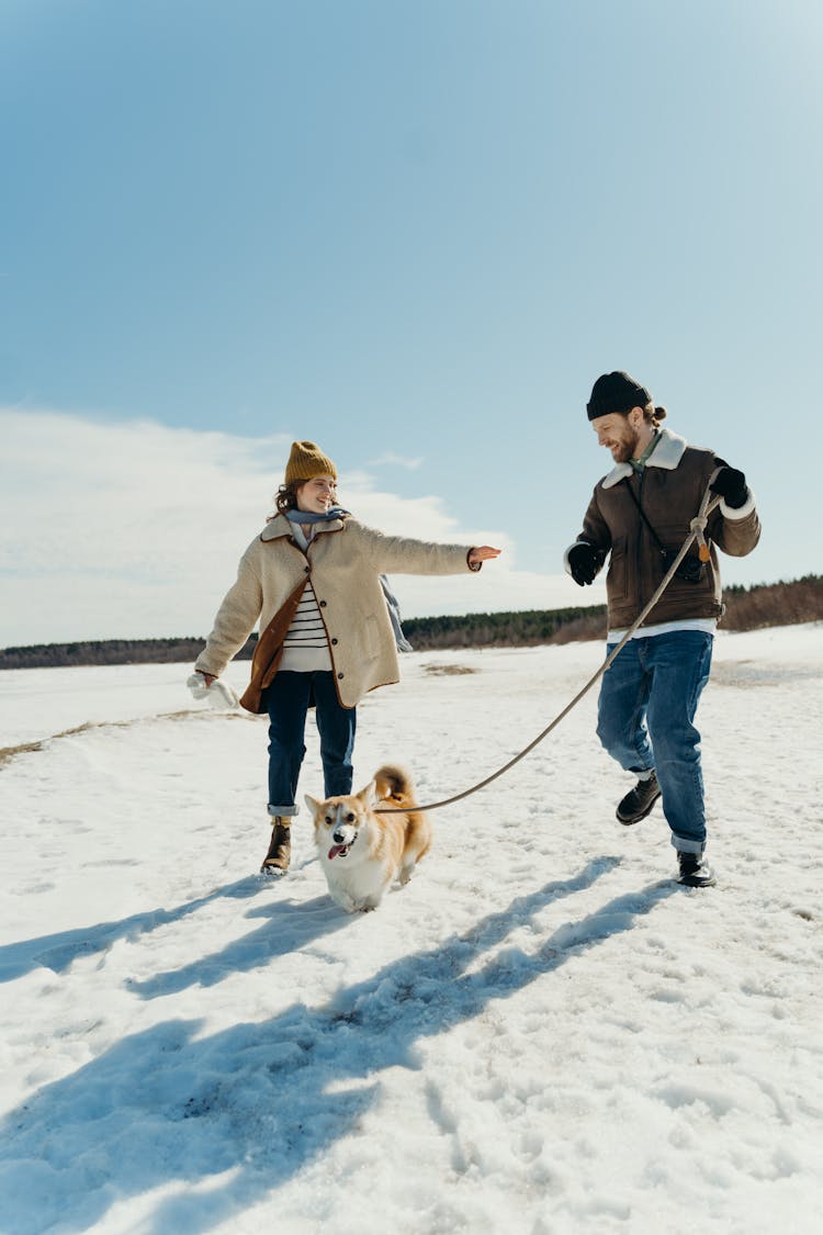 Man Running While Holding The Leash Of A Dog