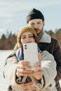 Boy in Gray Jacket Holding White Smartphone