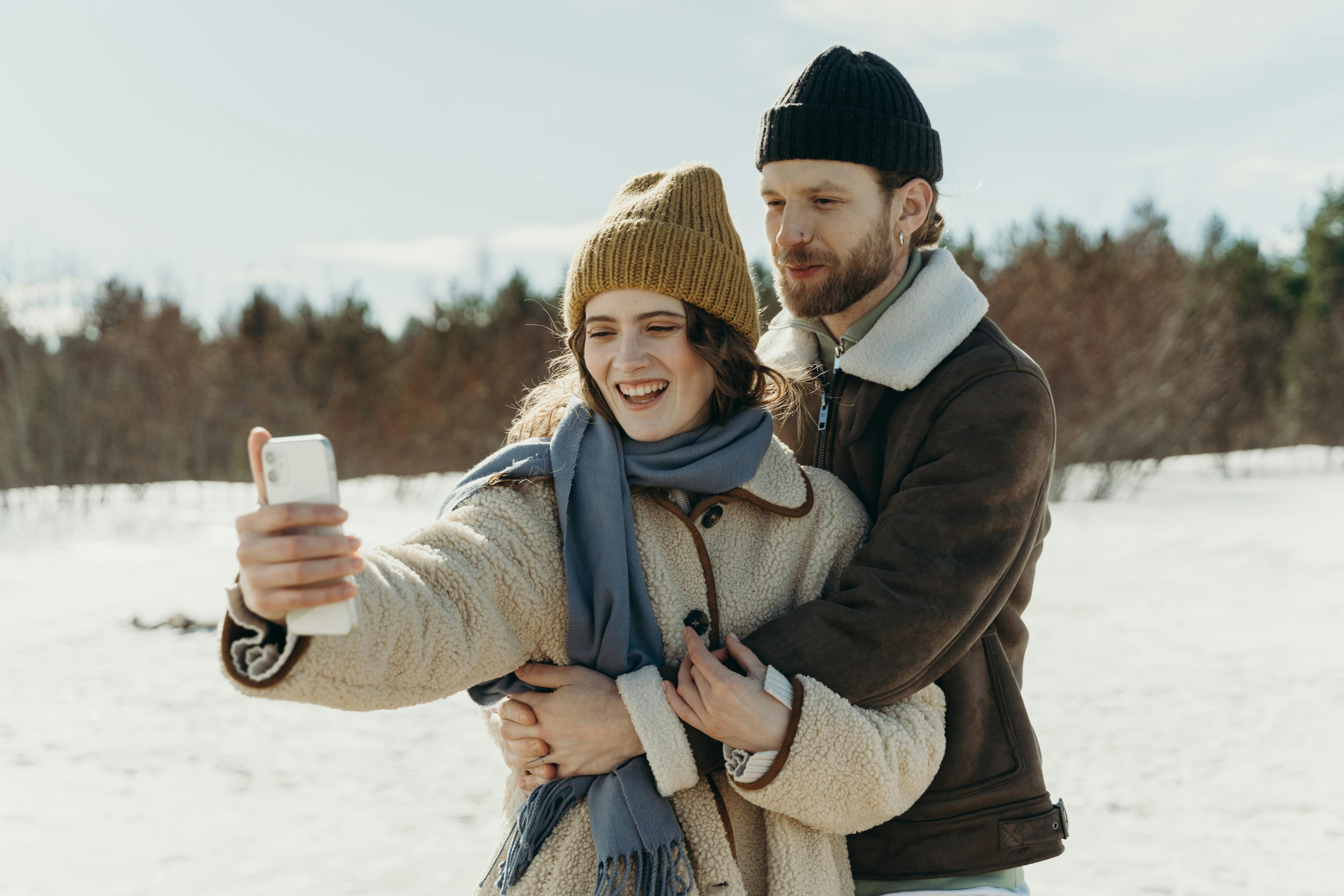 Woman in Winter Clothes Taking Selfie · Free Stock Photo