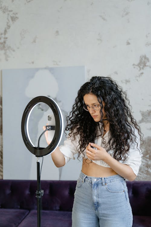 A Woman in a Crop Top and Denim Pants Vlogging