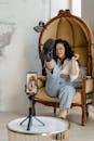 A Woman Vlogging while Sitting on a Chair
