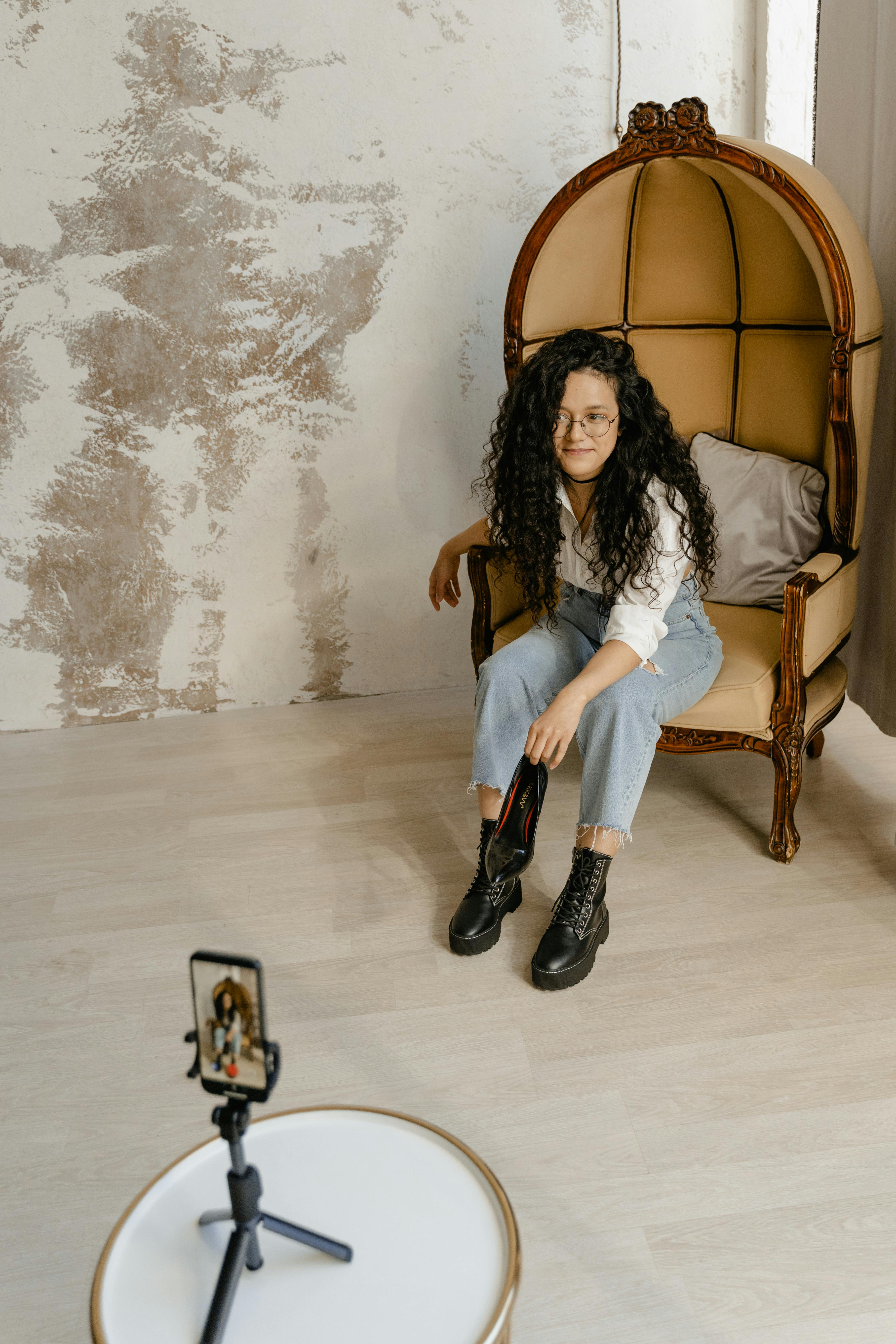 a fashionable woman posing while doing video recording