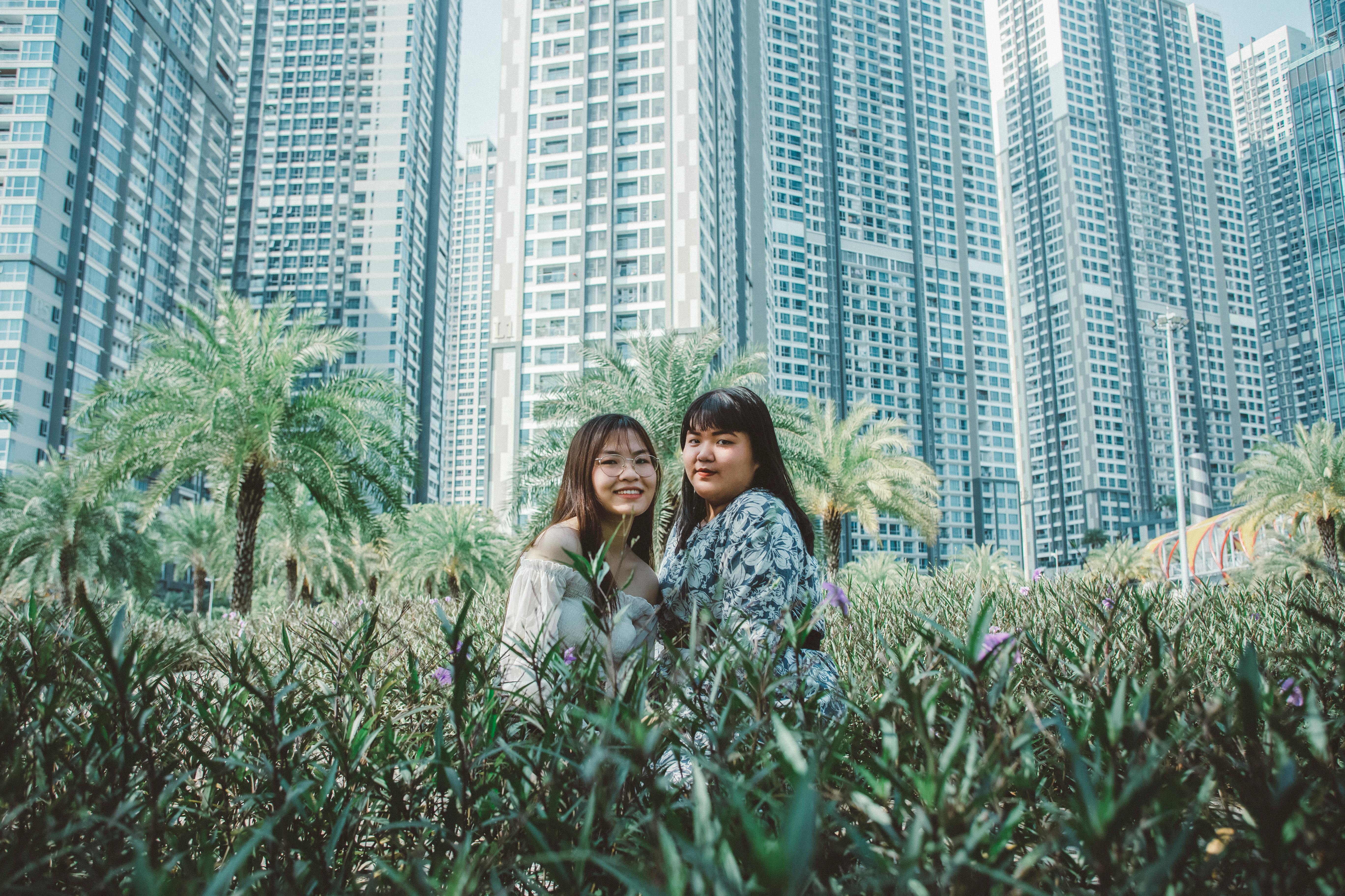 women posing among flowers in city