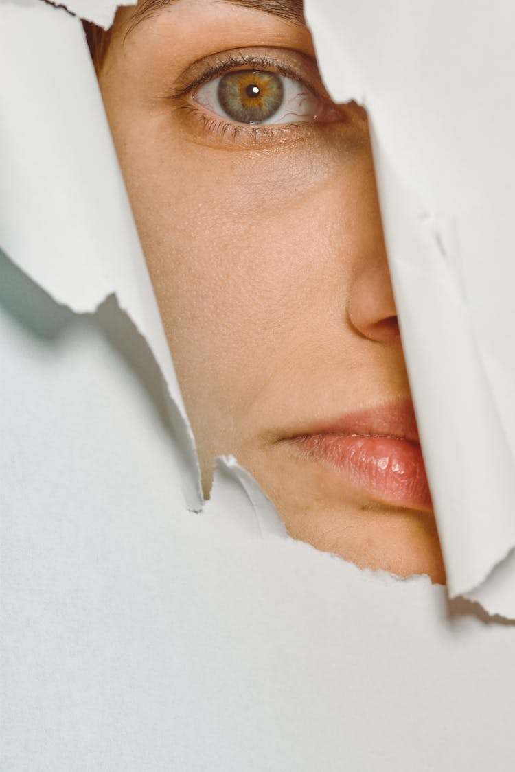 Woman Looking Through A Hole In The Paper