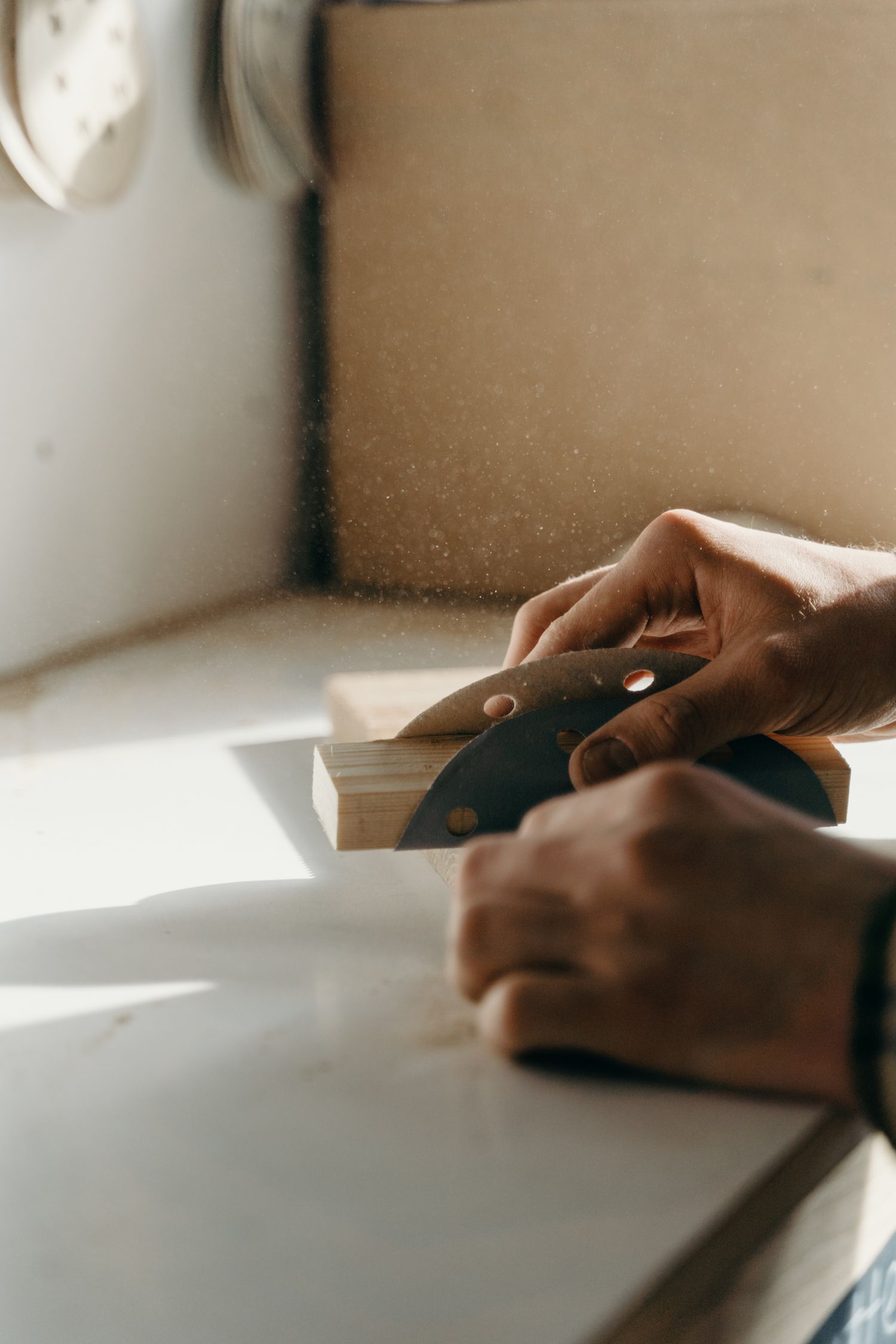 Craftsman sanding wood with precision and care