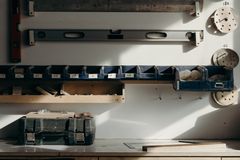 Well-organized workshop storage with tools and drawers in sunlight.