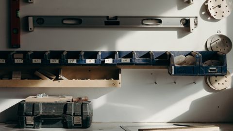Well-organized workshop storage with tools and drawers in sunlight.