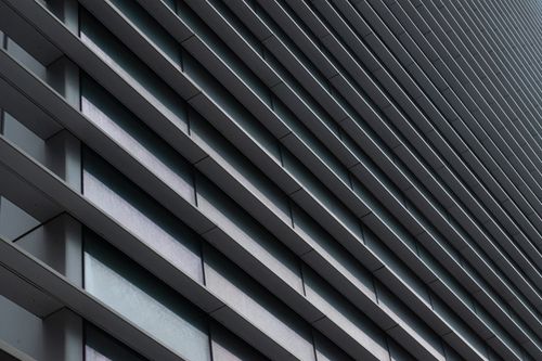 Free Close-up abstract view of modern architectural building with linear facade structure. Stock Photo